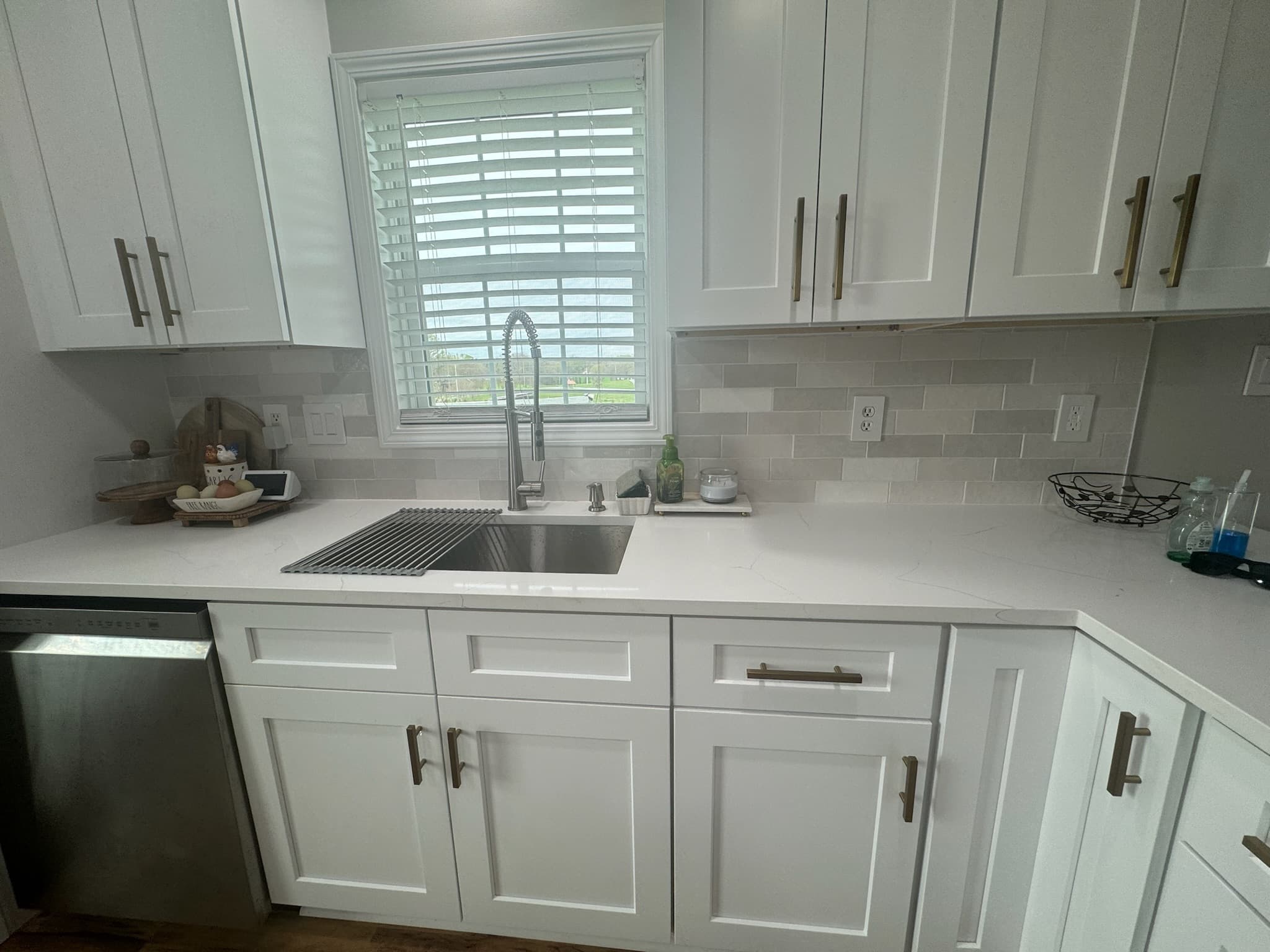 Modern kitchen renovation with white shaker cabinets, gray subway tile backsplash, and marble countertop island in Charlotte NC